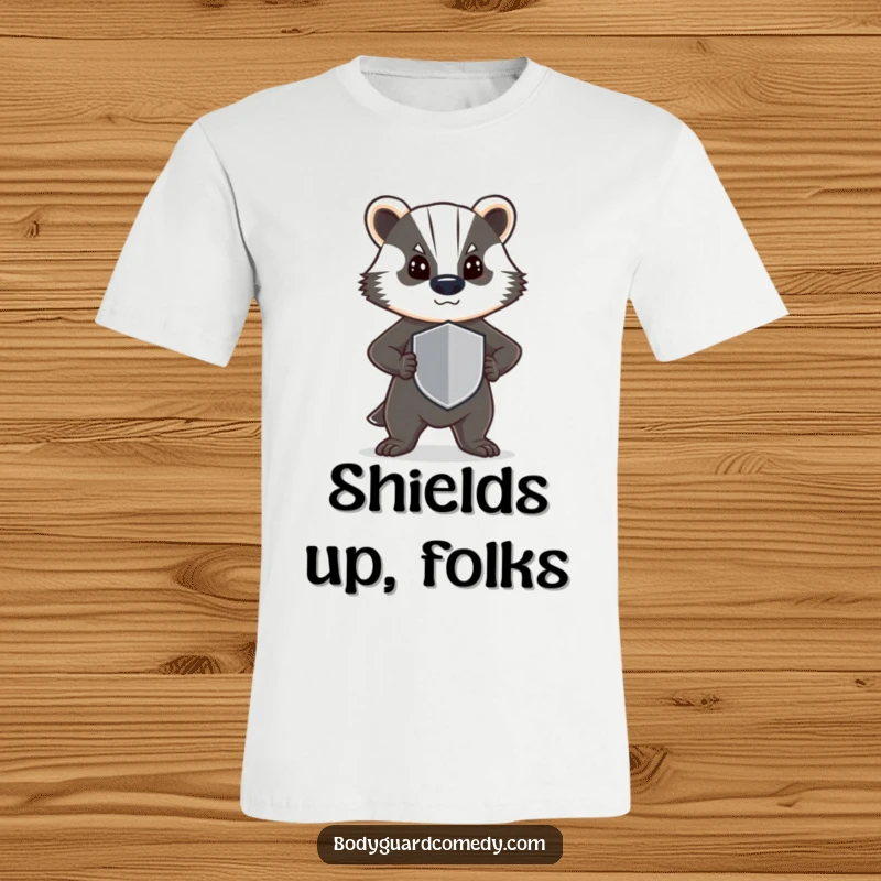 Funny t-shirt showcasing a steadfast badger, standing guard with a determined stance and a small shield, embodying resilience.