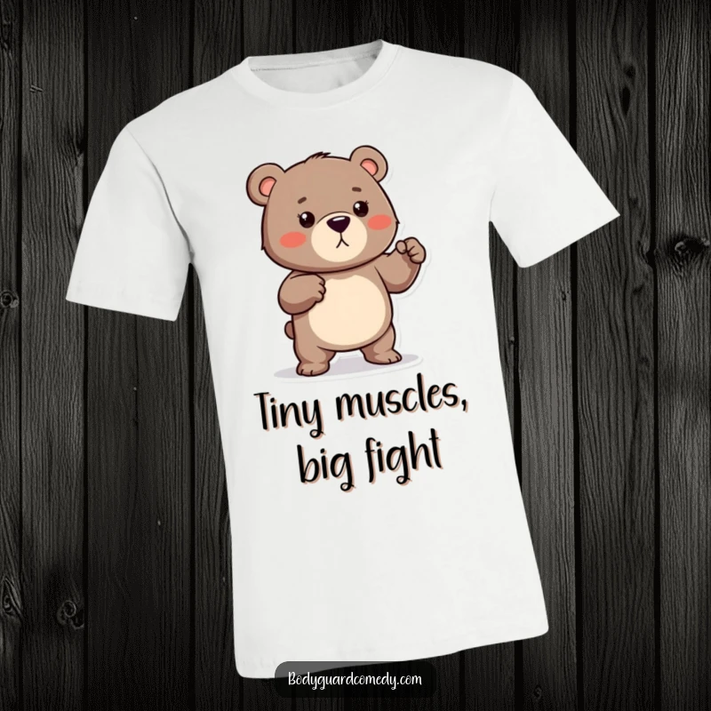 Funny t-shirt depicting a protective bear playfully flexing its small muscles, looking ready to defend with a humorous attitude.